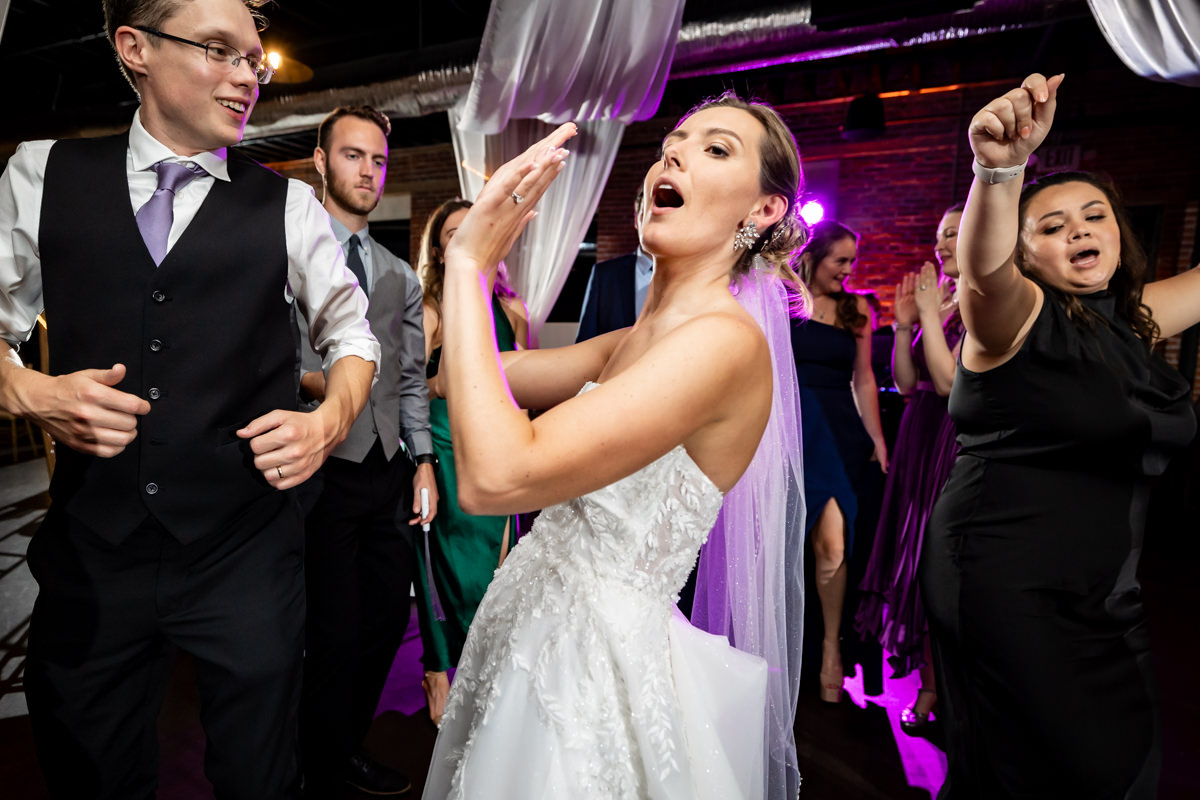 Bride having fun dancing and singing on the dance floor
