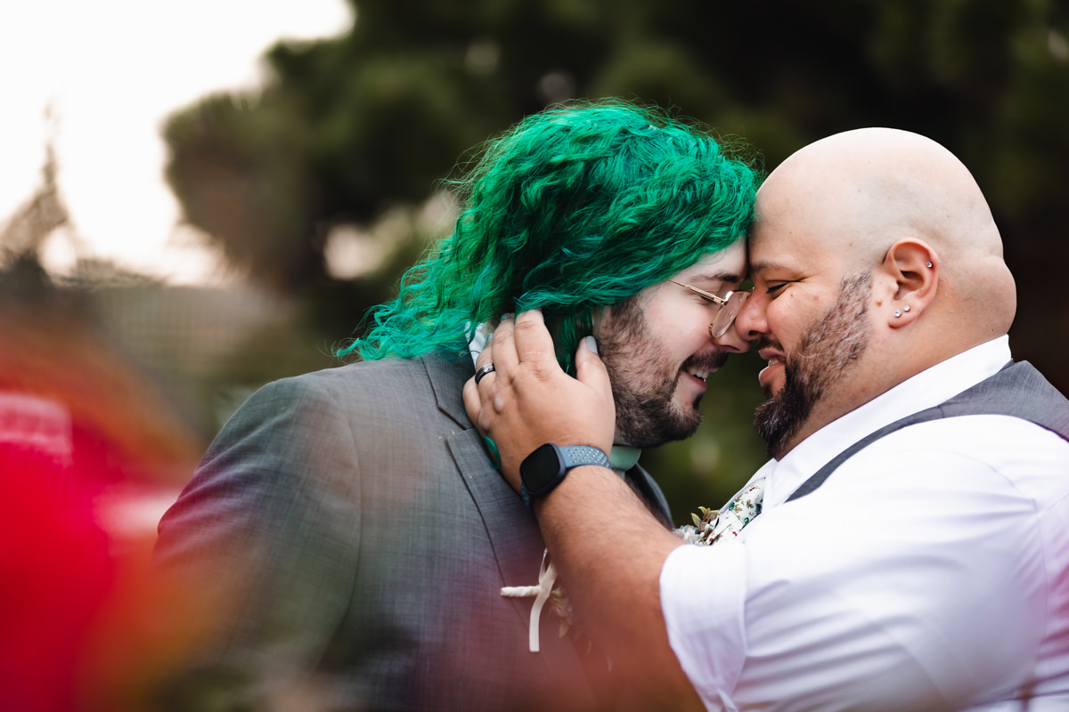 Gay couple enjoying a private moment with foreheads together