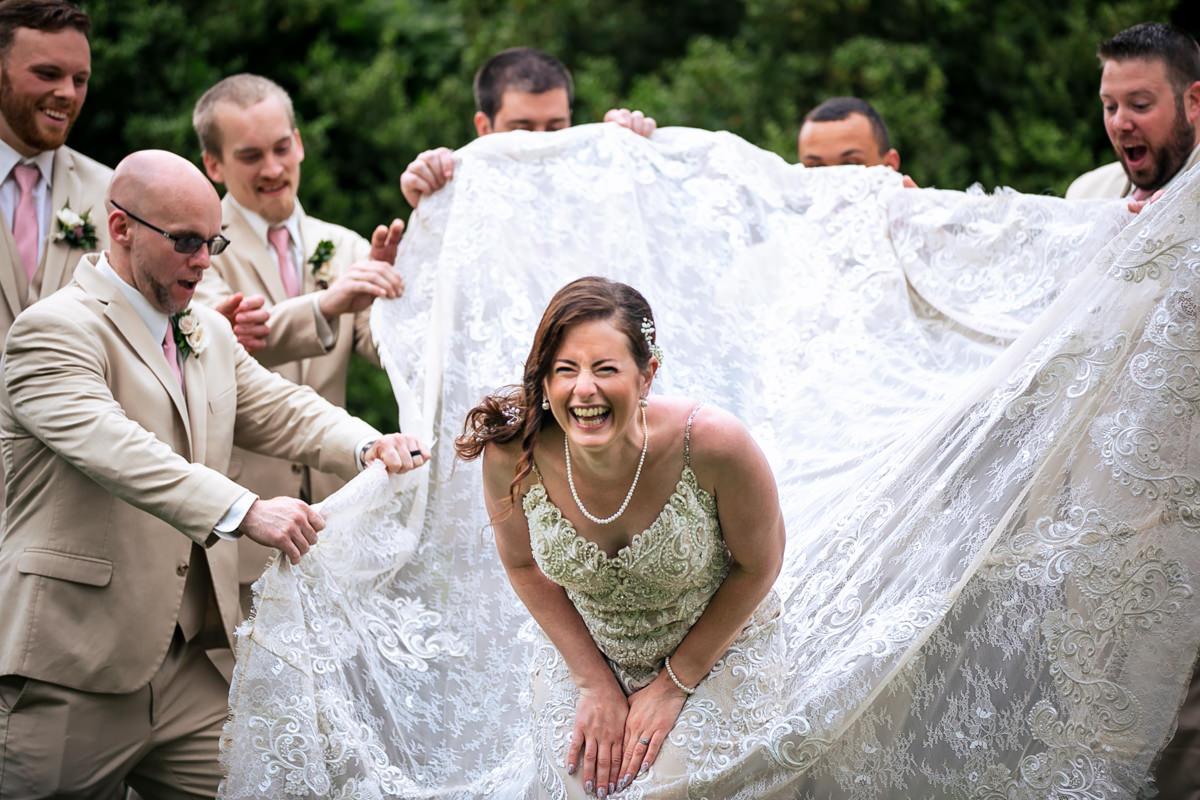 Groomsmen laughing with bride, photographed by a York PA wedding photographer