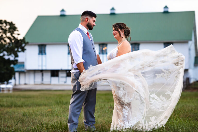 Couple letting go of the anxiety while they enjoy a moment together and bride waves her dress around
