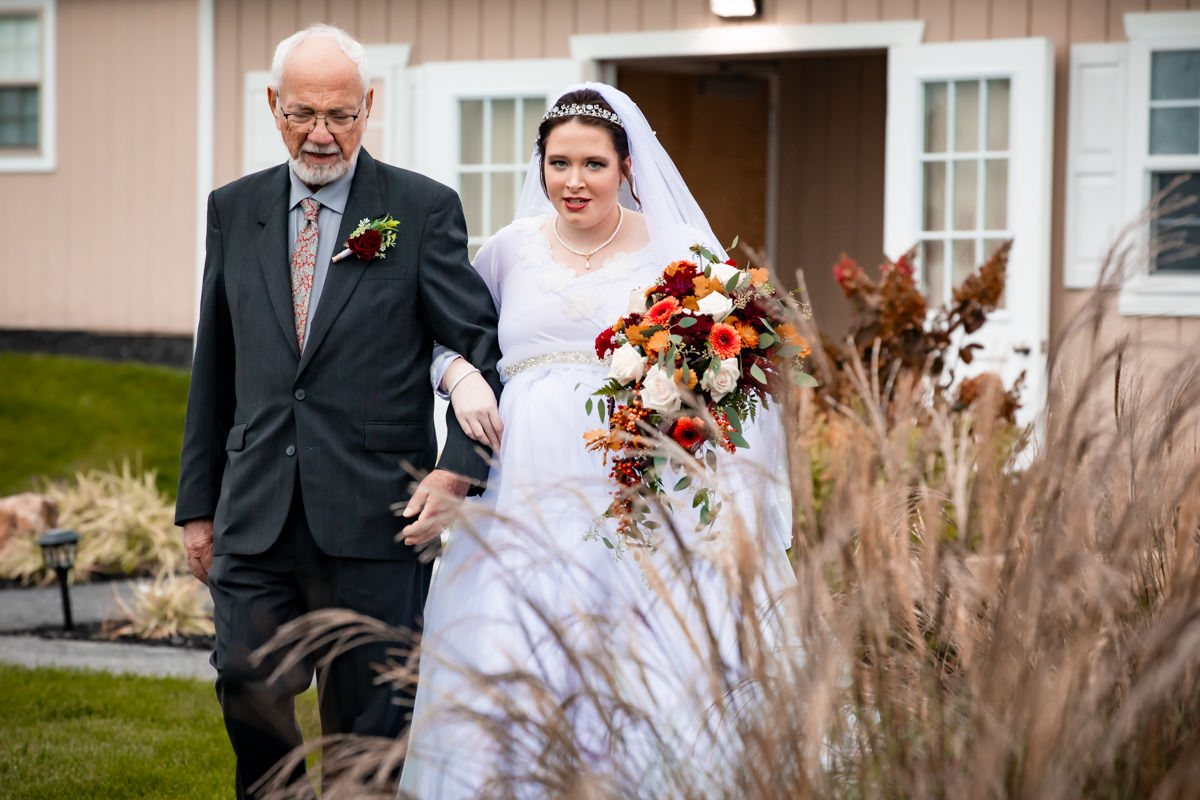 Father walking bride down the aisle with beautiful scenery at Brown's Orchard