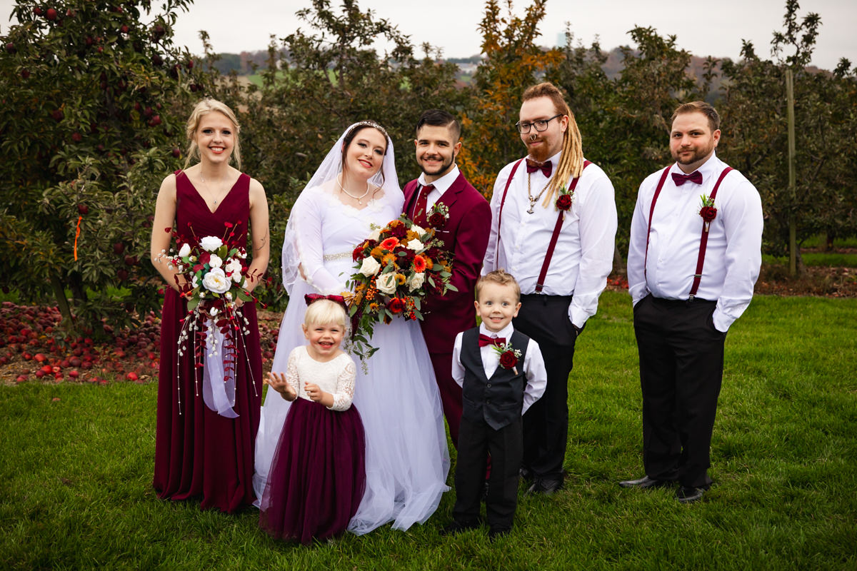 Couple celebrating their Brown’s Orchard wedding with wedding party in Loganville, Pennsylvania