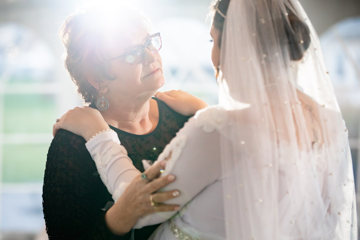 Mother dancing with bride at a Brown’s Orchard wedding