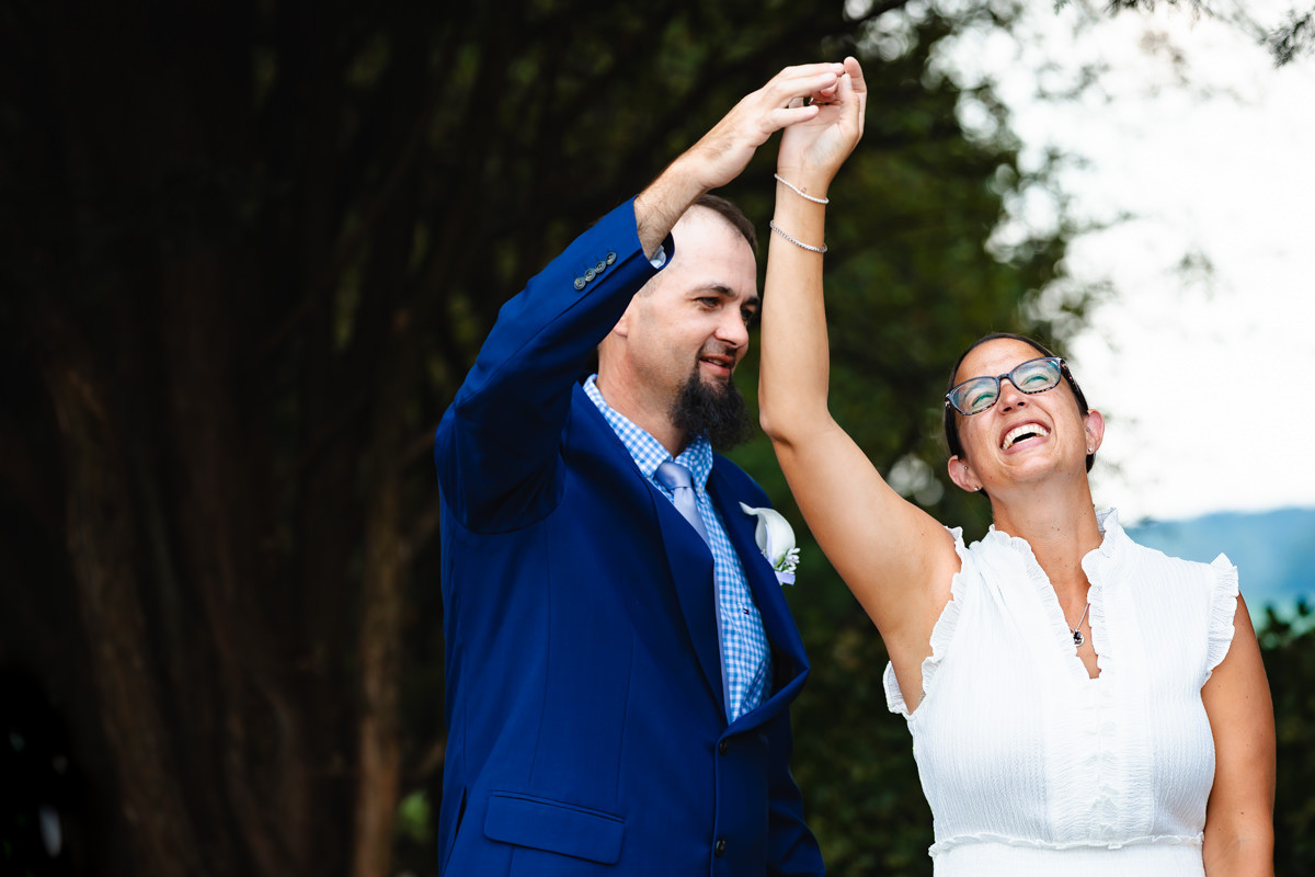 Groom twirling bride during portraits for their vow renewal