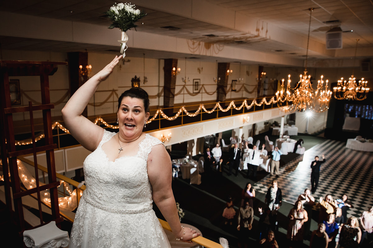 Bride throws her bouquet from the balcony to all the single ladies
