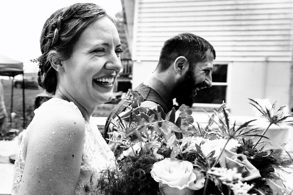 stress-free wedding photos during this rainy day backyard ceremony as bride and groom exit