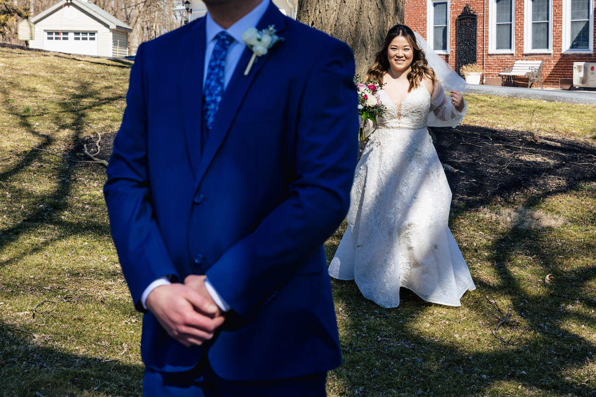 Bride approaching her husband for a first look