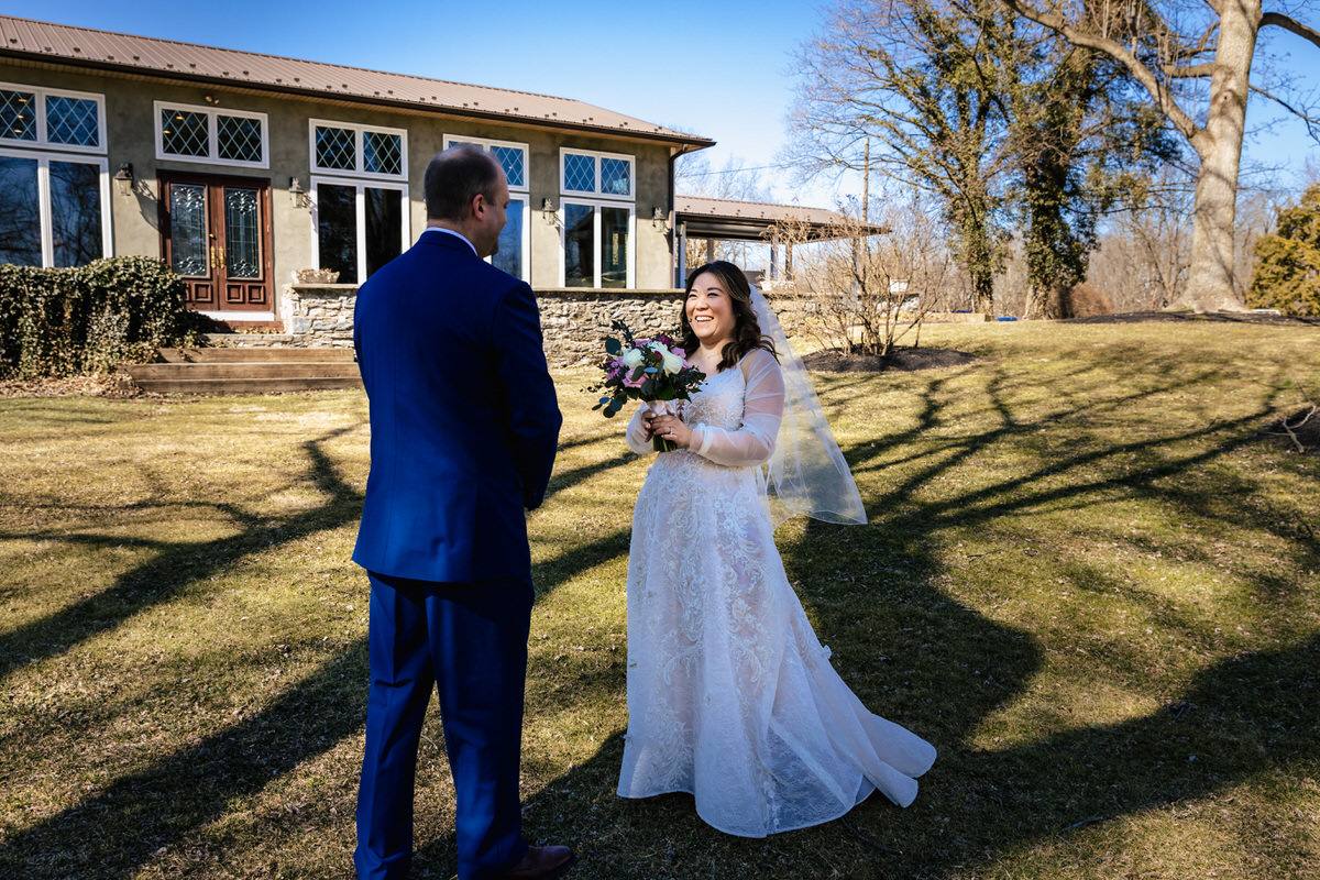 Couple enjoying their first look together outside the Conservatory at their Cameron Estate Inn Wedding