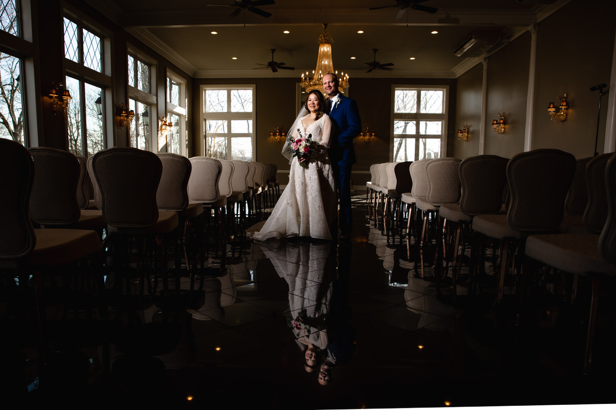 The couple lit perfectly for a portrait in the Conservatory at this Cameron Estate Inn Wedding, their reflection shown in the marble floor