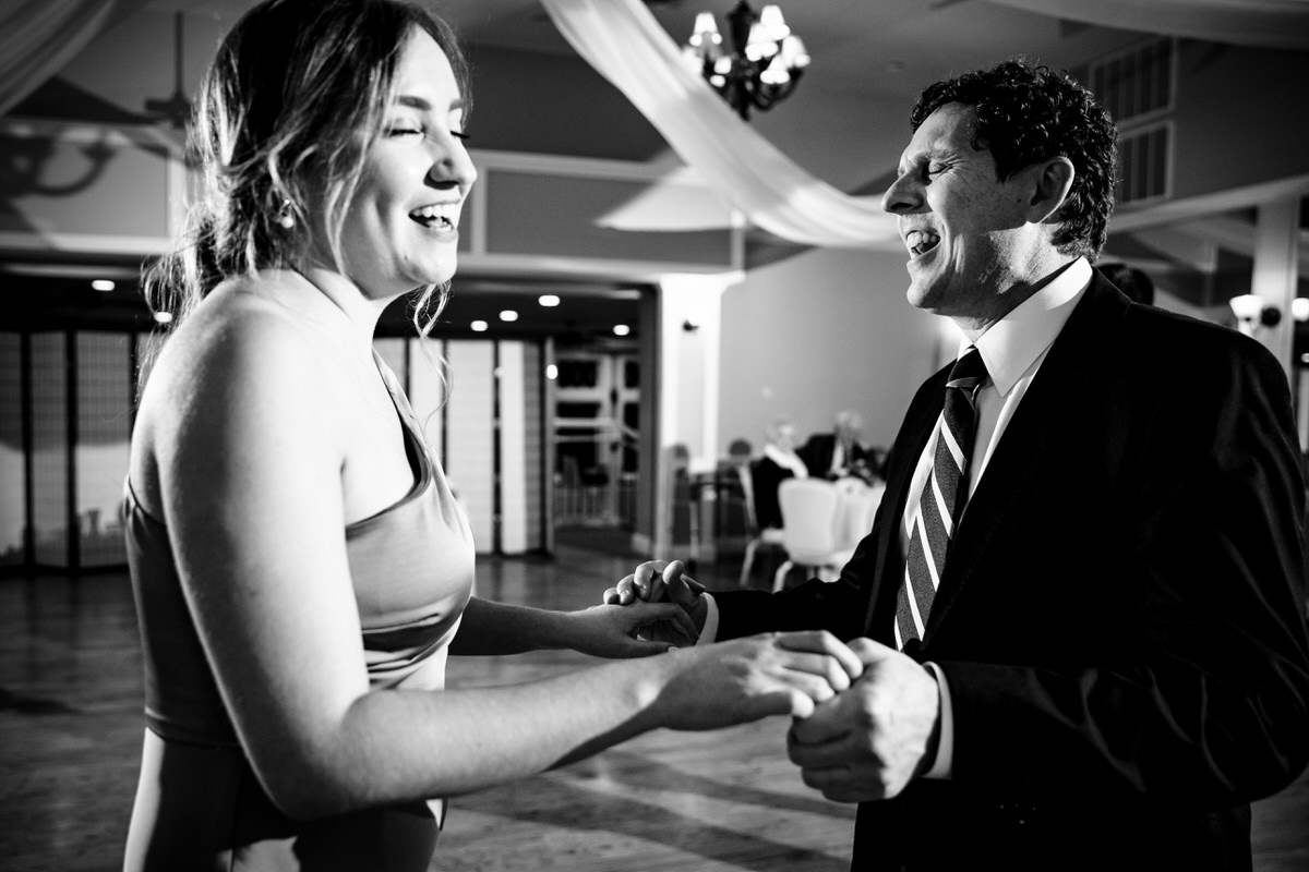 Wedding guests holding hands and dancing to the music