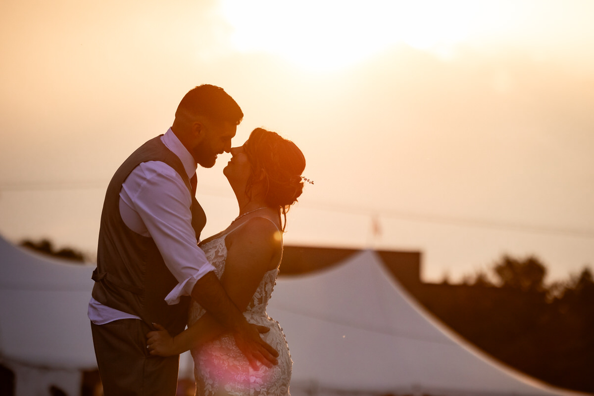 Couple enjoying the romantic orange glow of the sunset