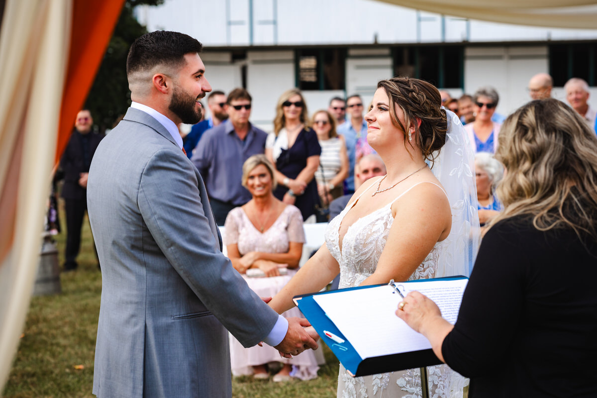 Bride and groom smiling at each other during the ceremony