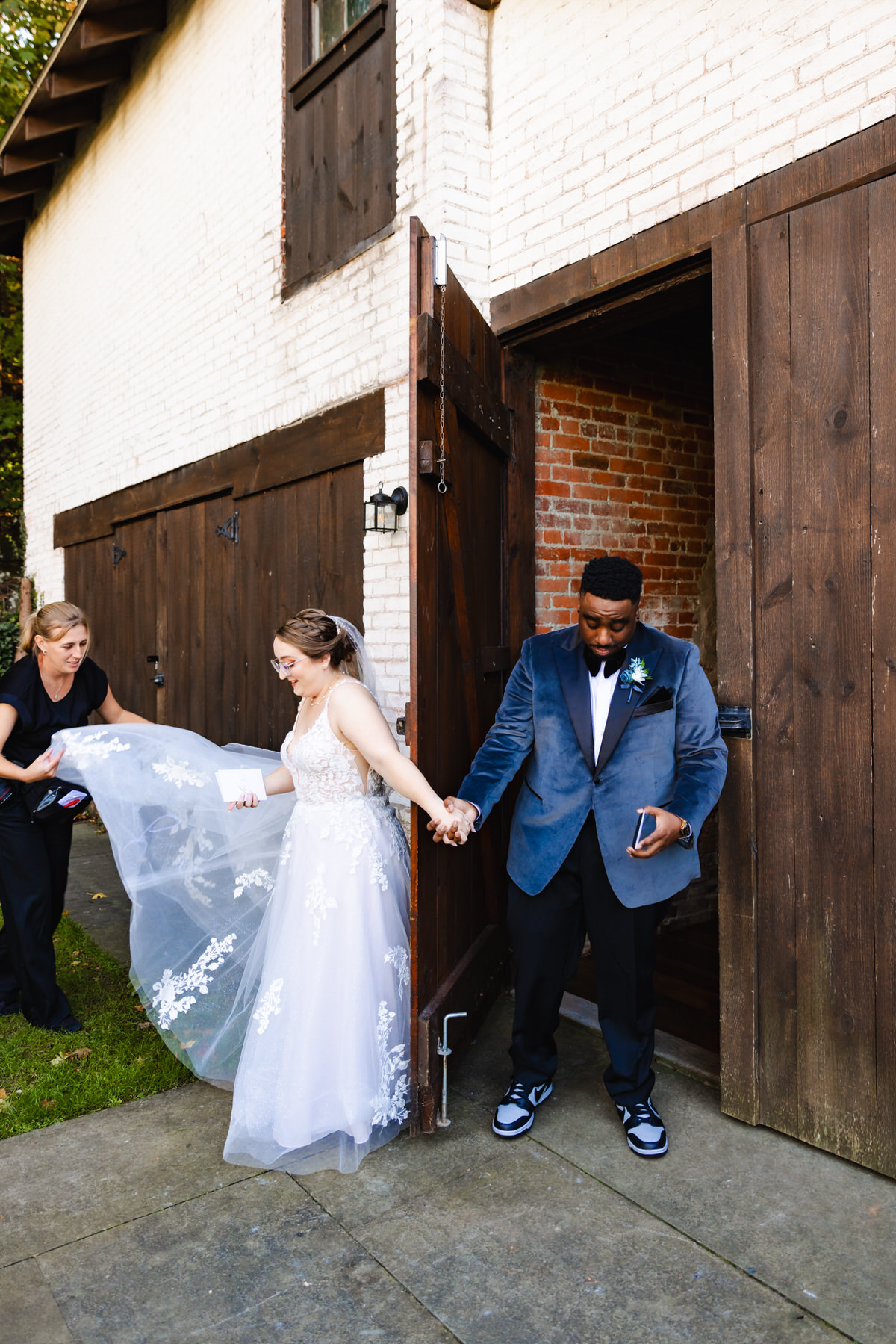 Kelly helping bride fix her dress to make sure everything looks great for their first touch