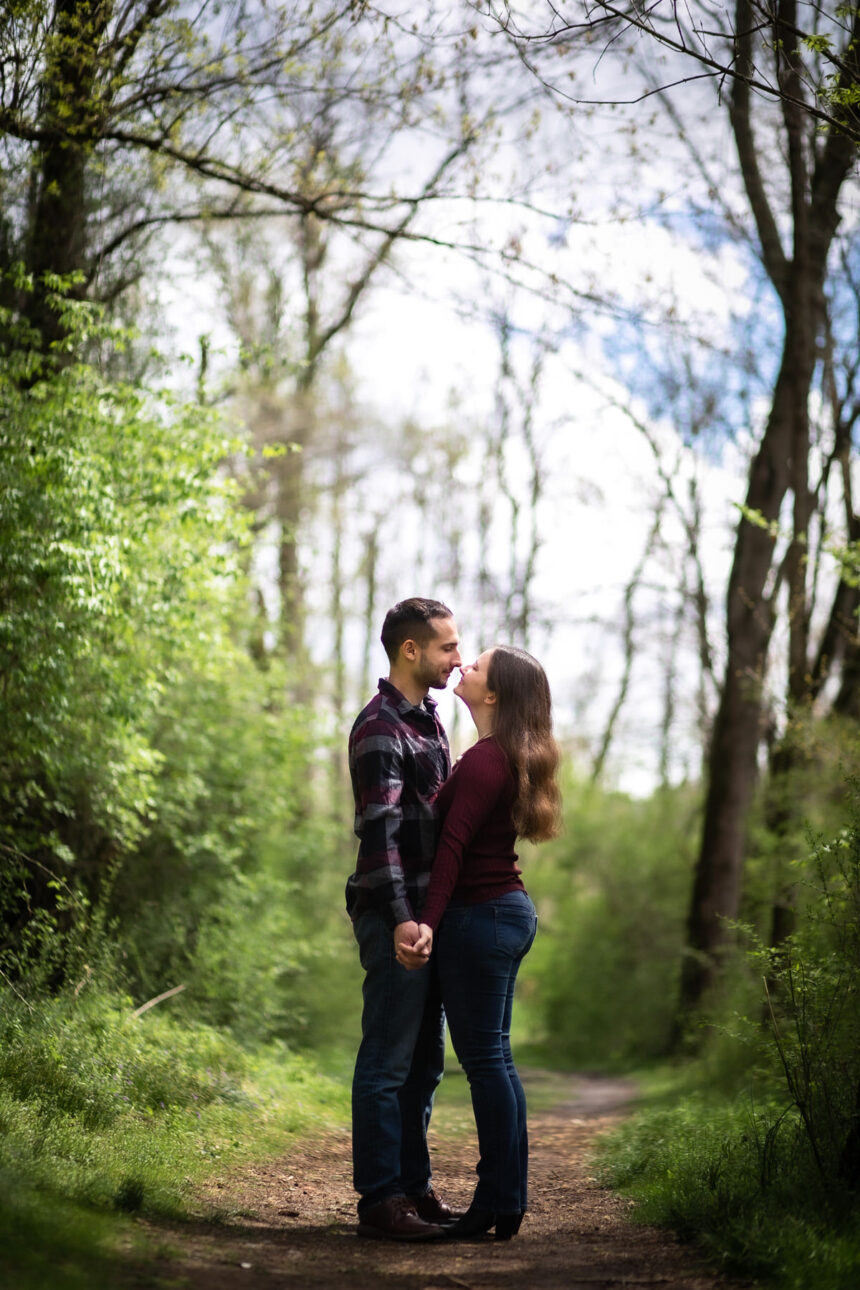 Couple facing each other while holding hands during their Lake Redman engagement session
