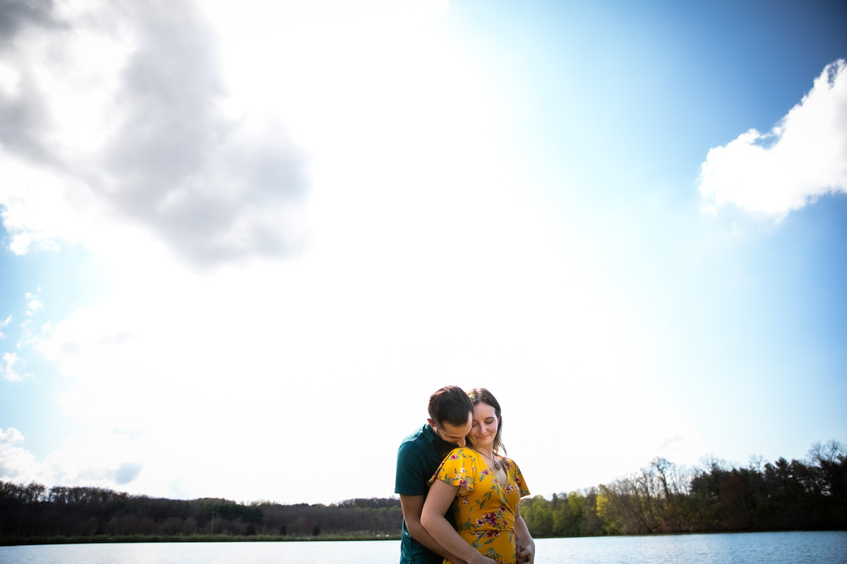 Couple enjoying a moment with the bright blue sky and Lake Redman in the background