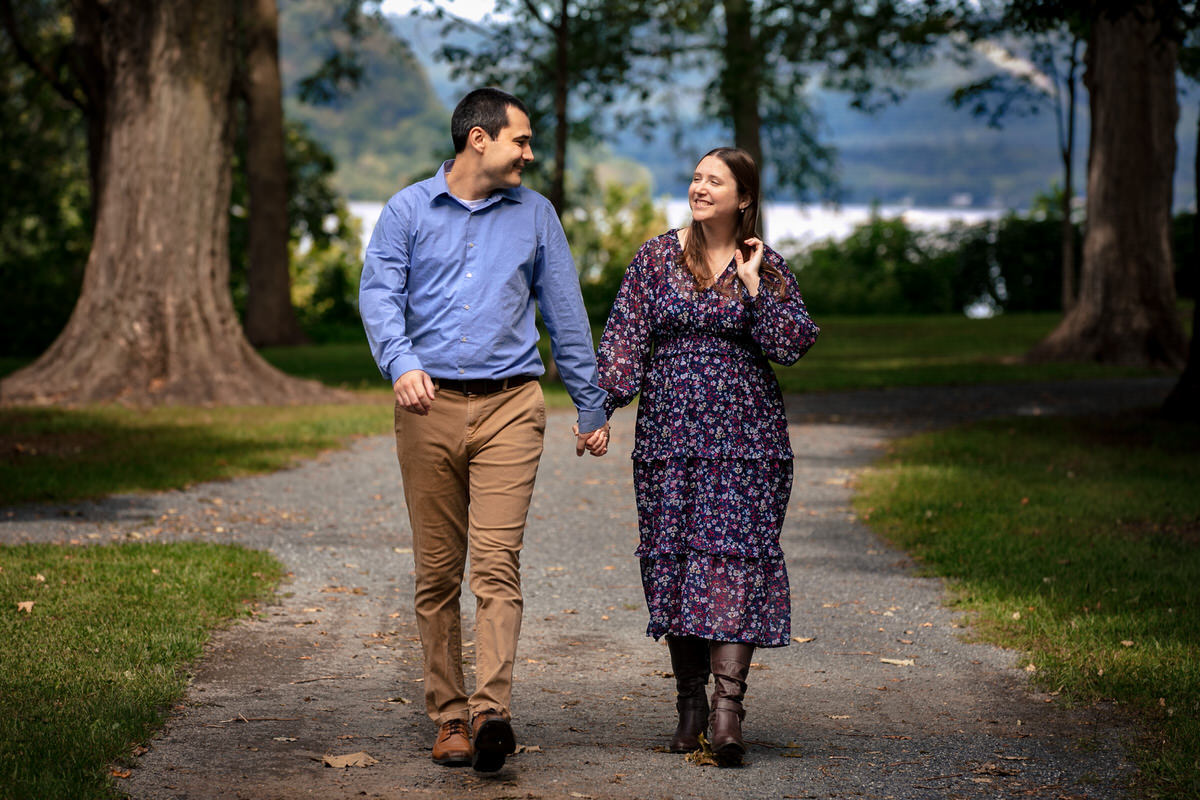 Holding hands as Mariah and Chris walk down a tree lined path at their  Fort Hunter Engagement Photos