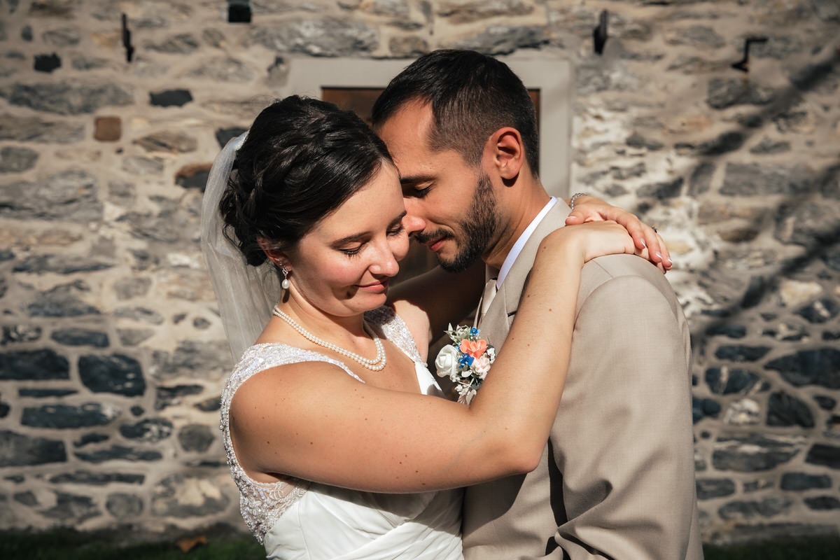 Lancaster Wedding Photographer captures couple embracing each other at The Mill at Manor Falls